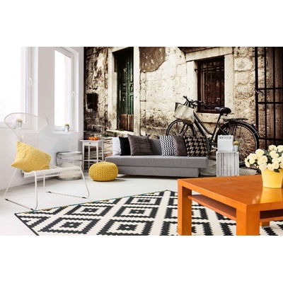 DIMEX ART Самозалепваща се флизелинова фототапета колело до каменна стена 375 x 250 см