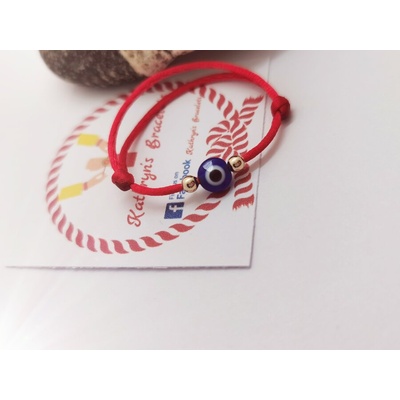 Червен конец със злато и синьо око за бебе