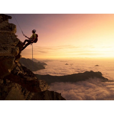 Plakát, Obraz - Climber on a rocky wall over clouds, Buena Vista Images, 40 × 30 cm
