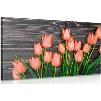 Obraz očarujúce oranžové tulipány na drevenom podklade