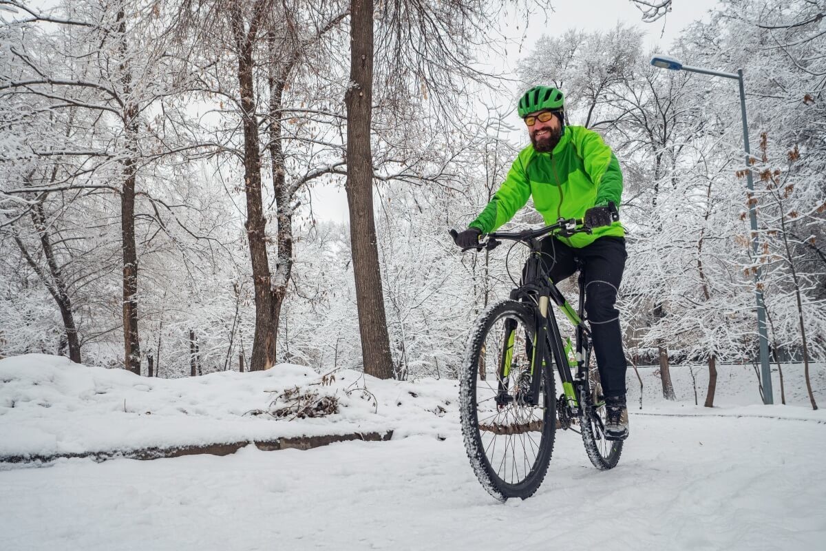 Ciclist îmbrăcat în echipament corespunzător în timpul unei excursii cu bicicleta iarna De ce să alegi haine speciale pentru ciclism